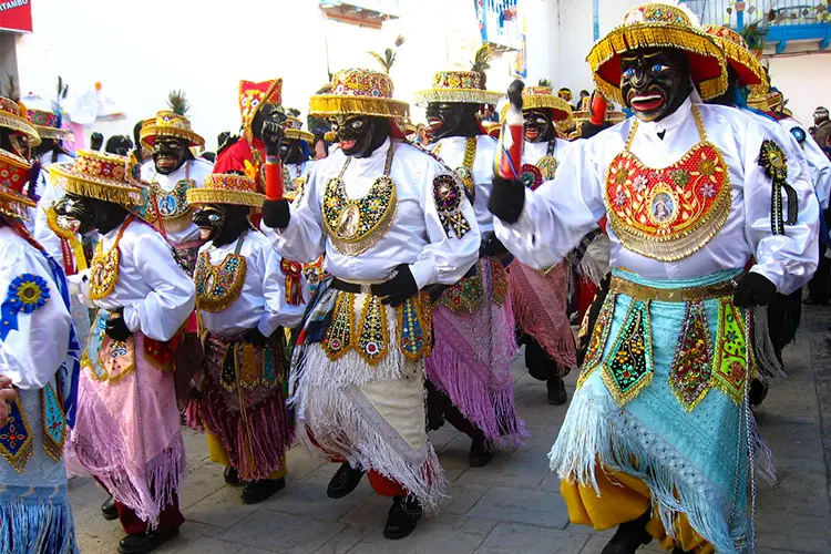 Traditional dancers celebrating one of the famous festivals in Cusco, Peru, wearing colorful costumes during an authentic Andean cultural celebration.