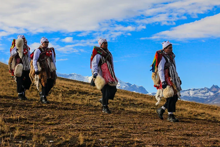 Ukukus at the Qoyllur Rit'i Festival in Peru wearing traditional costumes during the sacred Andean pilgrimage.